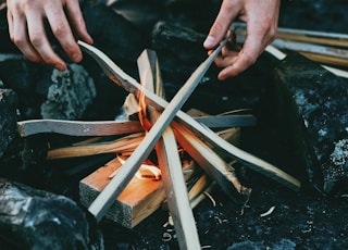 person holding gray wooden wood