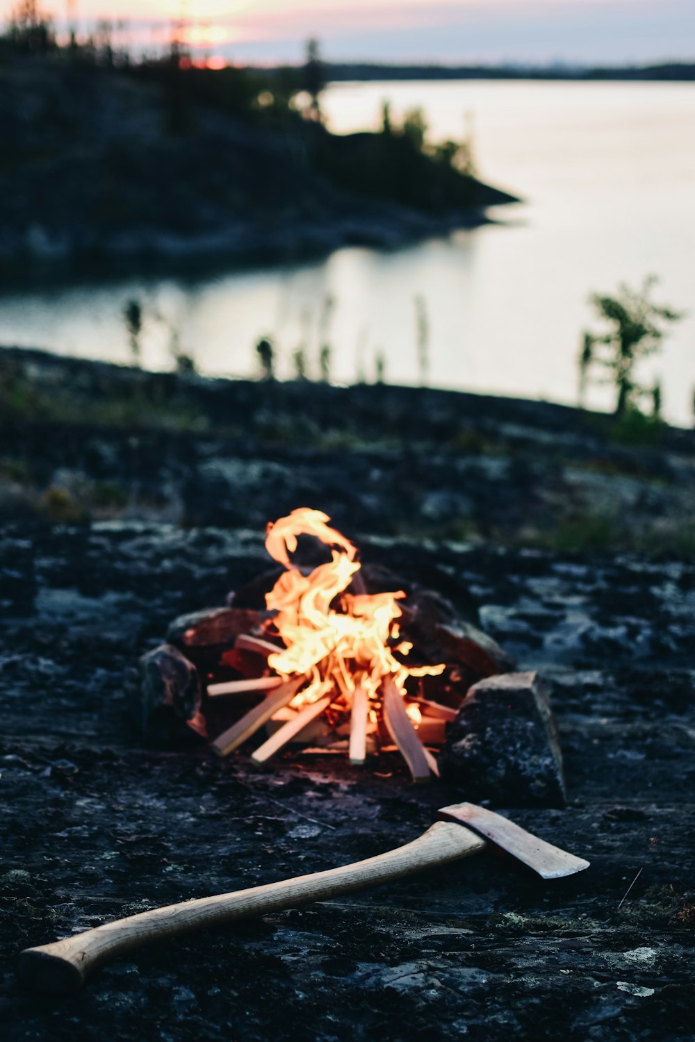 mini bonfire beside a hatchet