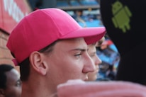 A close-up photo of a pink cap with Schwesta Ebra Merch logo in bubbly font.