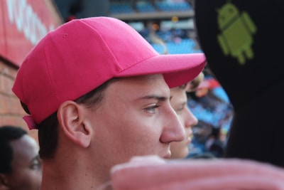 A close-up photo of a pink cap with Schwesta Ebra Merch logo in bubbly font.
