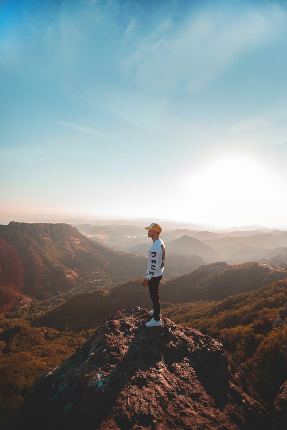 man standing on hill top during daytime