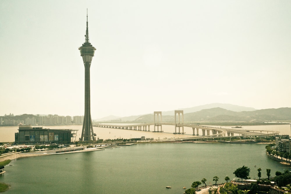 gray tower near body of water during daytime