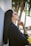 woman in black long-sleeved shirt standing against wall