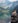 woman sitting on rock near lake