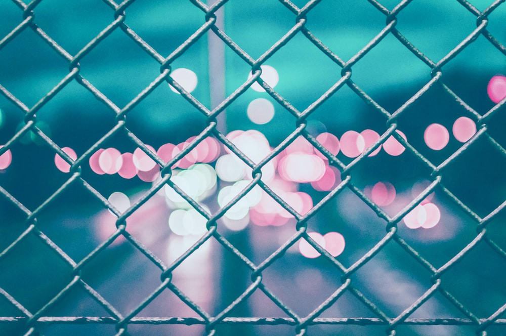 chain link fence with bokeh lights