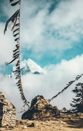 two clothes line attached to stone near snow capped mountain at daytime