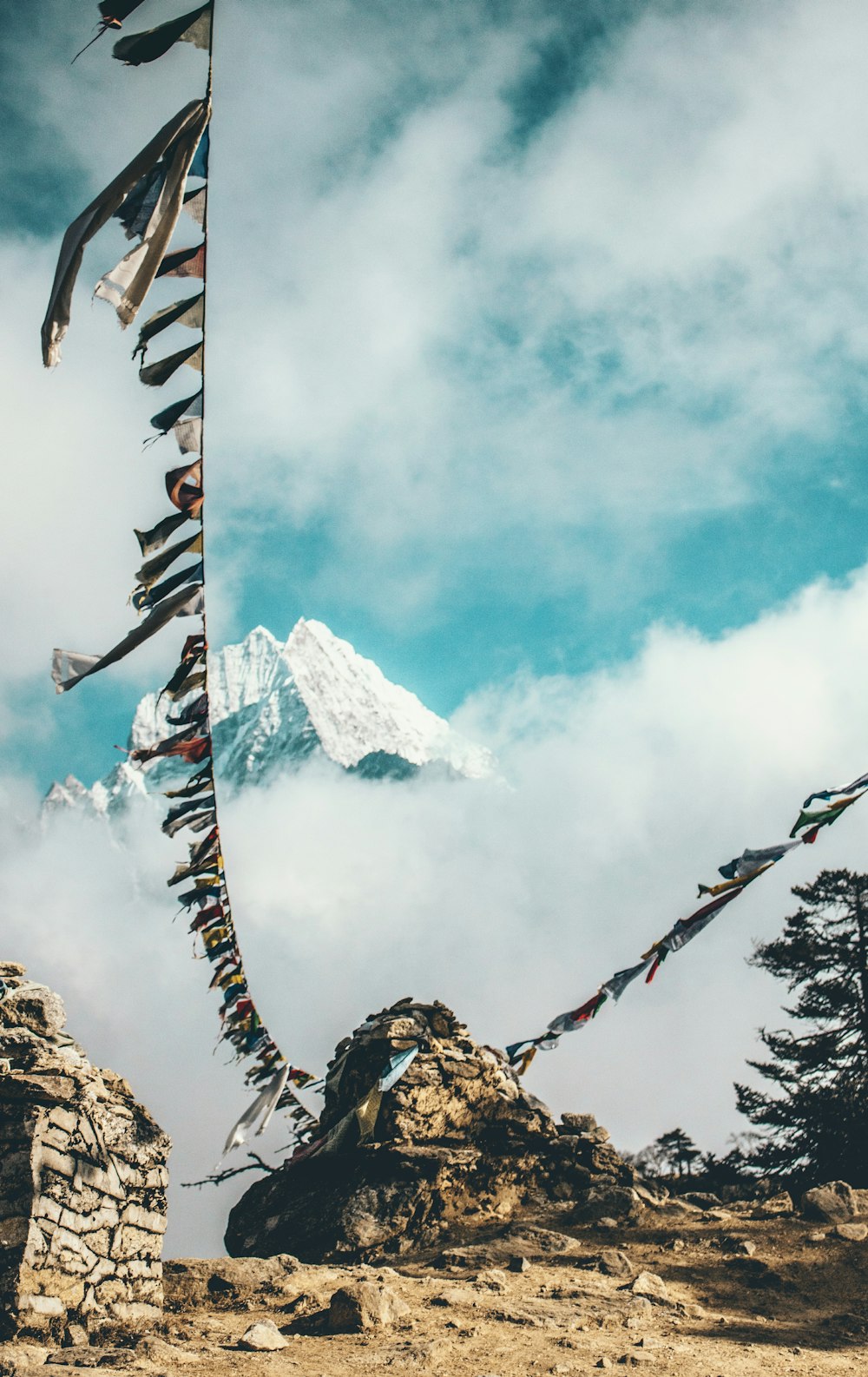 two clothes line attached to stone near snow capped mountain at daytime