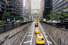 vehicles on road near buildings