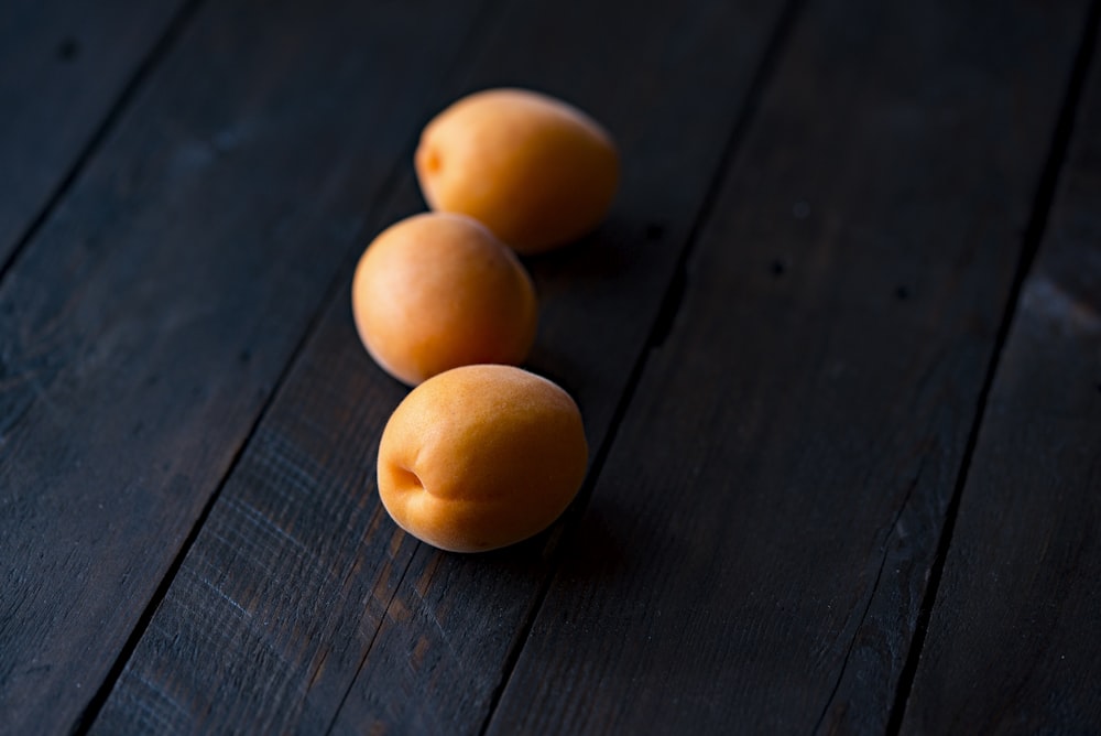 three fruits on wooden surface