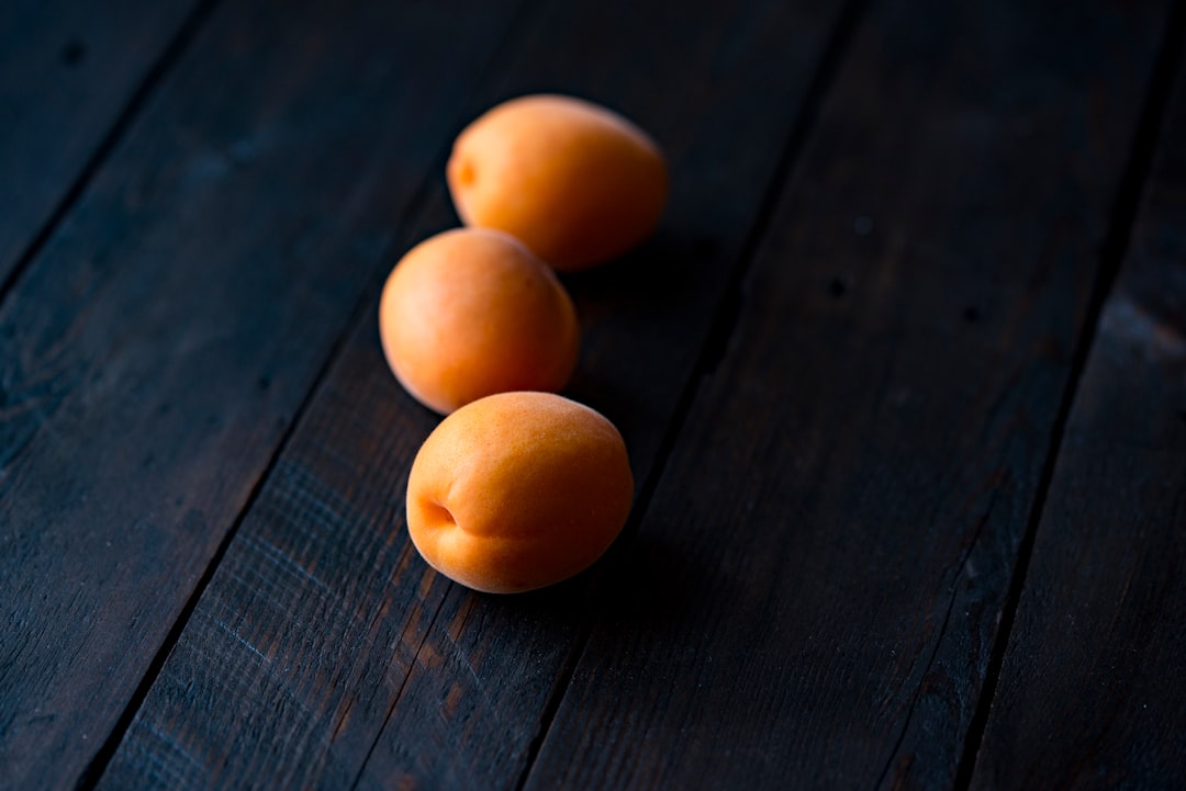 three fruits on wooden surface