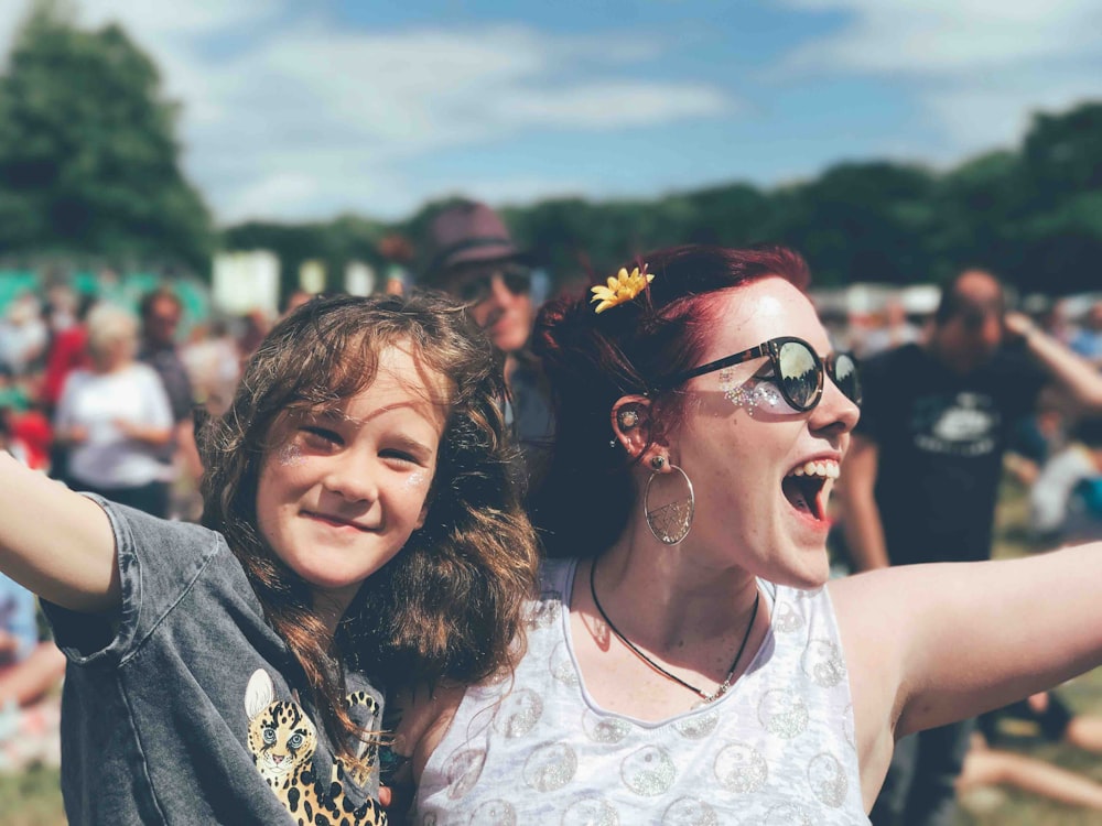 girl and woman near people at the field during day