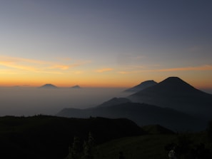 A serene landscape of the Rocky Mountains at dawn.