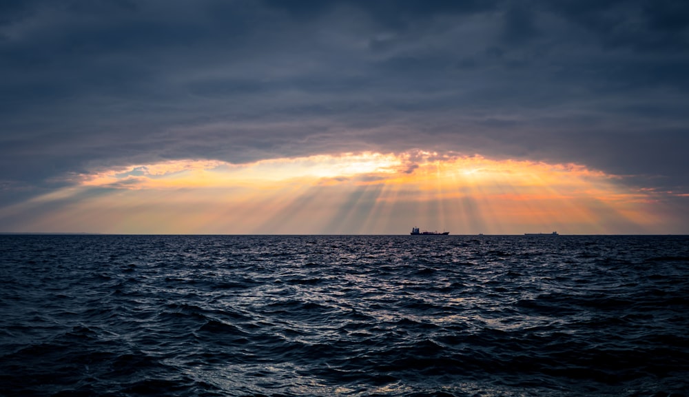 calm wave body of water during sunset