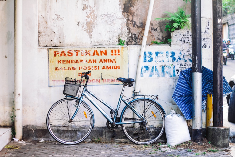 blue bicycle near wall