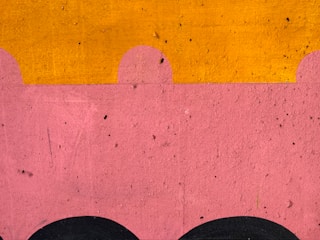 Close-up of a colorful custom tufted wall art piece with soft pastel tones.