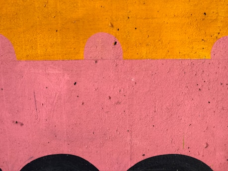 Close-up of a colorful custom tufted wall art piece with soft pastel tones.