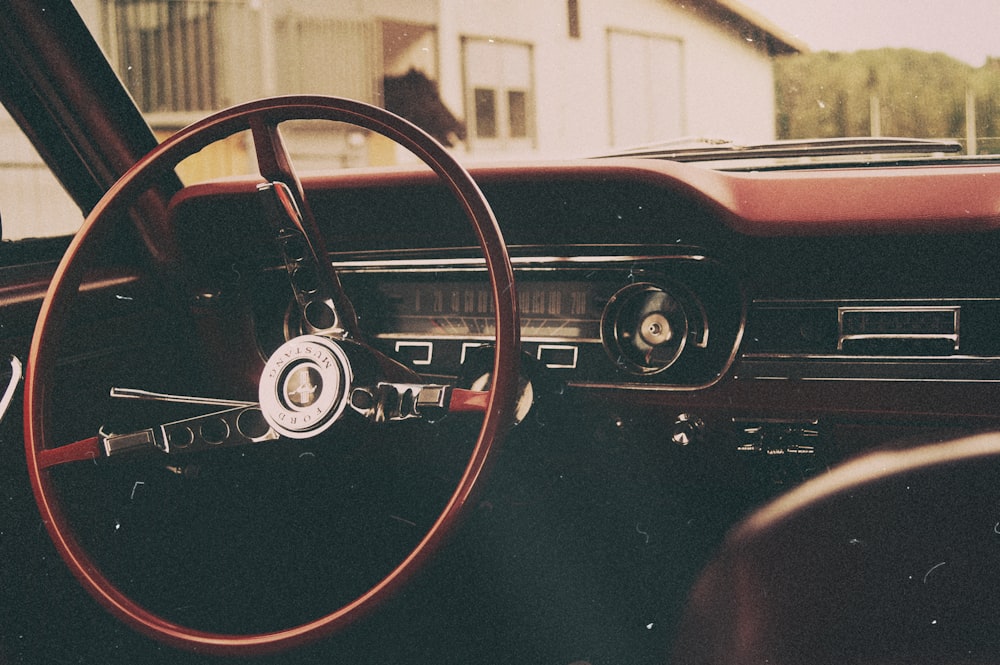 Foto de enfoque selectivo del volante del automóvil rojo y gris