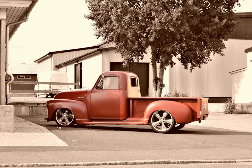 sepia photography of parked classic red single cab pickup truck