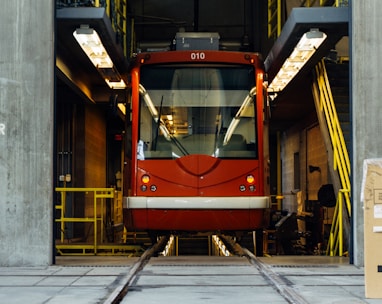 red train in between gray concrete wall