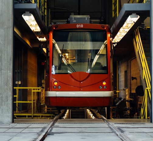 red train in between gray concrete wall