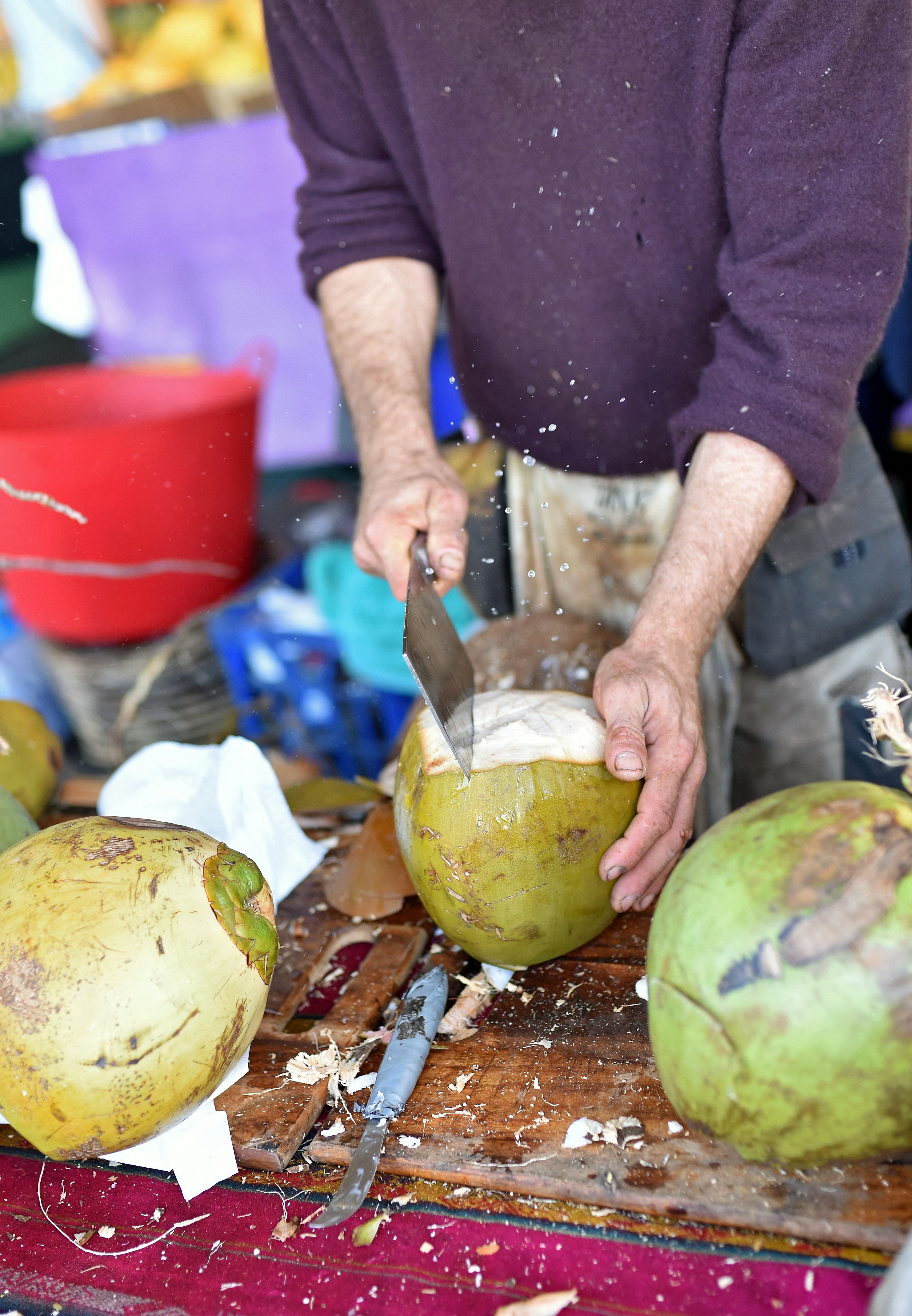 man slicing coconut