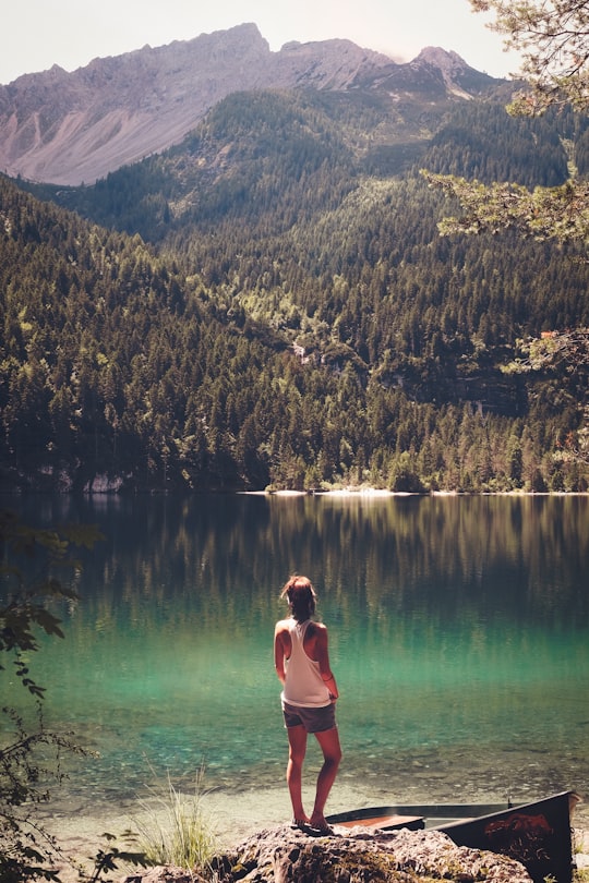 woman standing in front of body of water in Lago di Tovel Italy