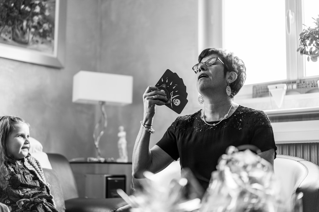 woman in black t-shirt holding playing cards