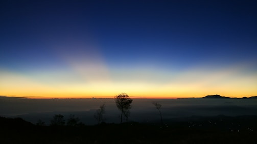 A serene landscape at dusk with muted colors and gentle shadows.