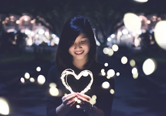 A woman holding a heart