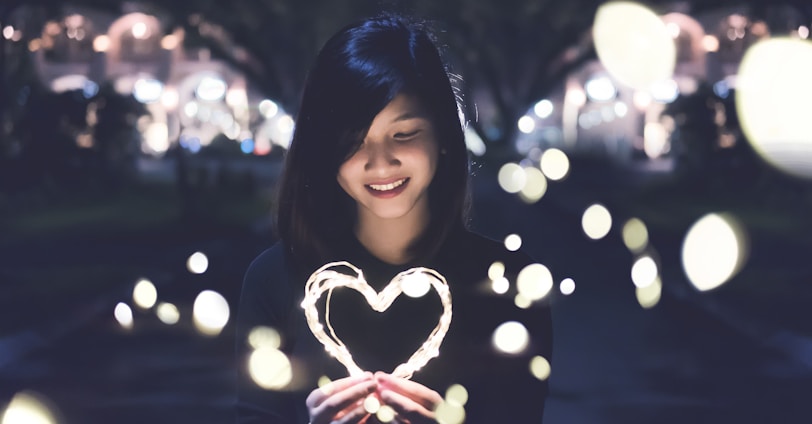 A woman holding a heart