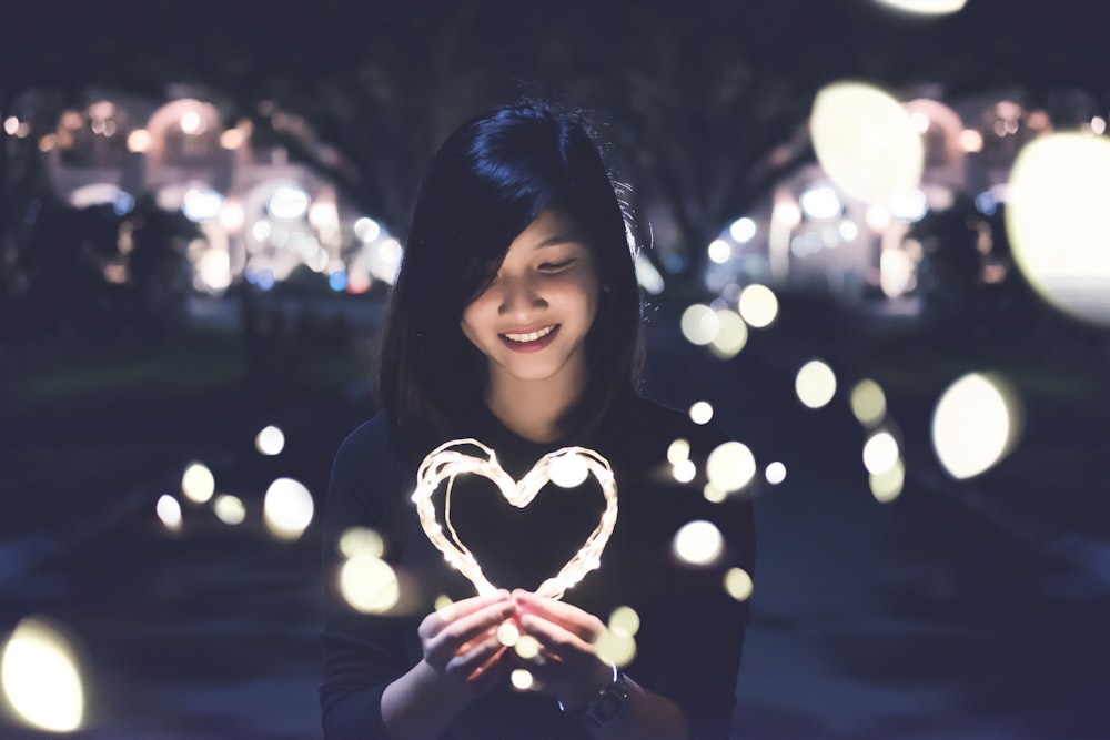 A woman holding a heart