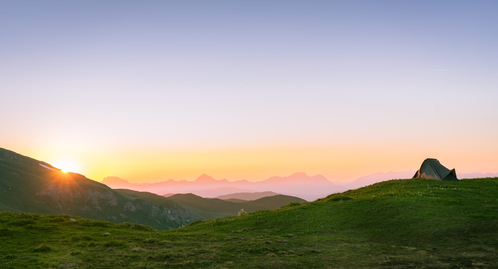 silhouette photography of green field at golden hour