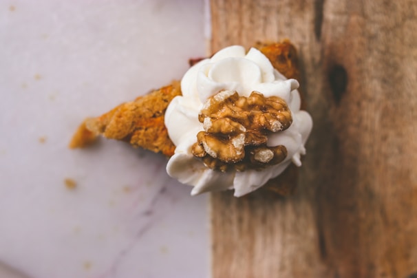 A decadent slice of pecan pie topped with whipped cream.