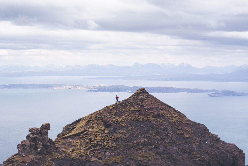 person walking on brown mountain