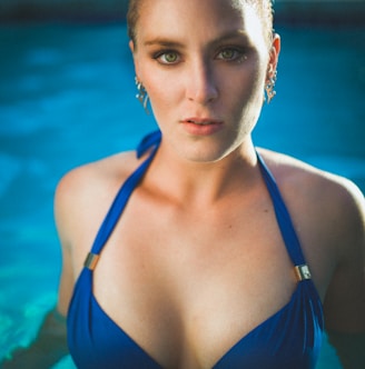 woman in blue string bikini top in pool looking straight