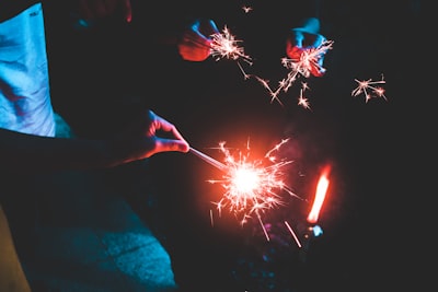 people holding sparklers sparkle zoom background