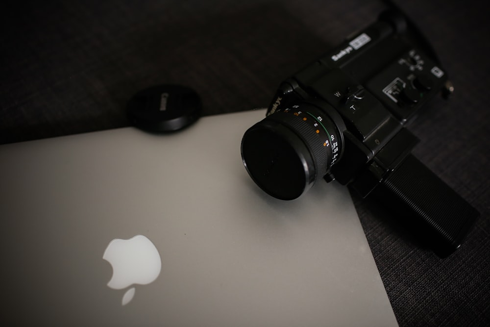 a camera sitting on top of a laptop computer