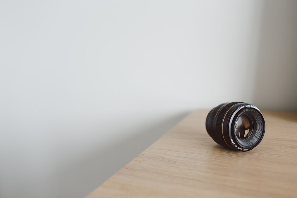 black camera lens on brown table