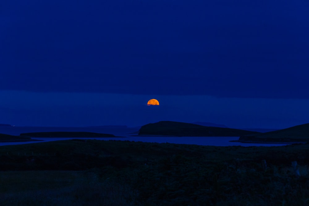 orange moon during nighttime