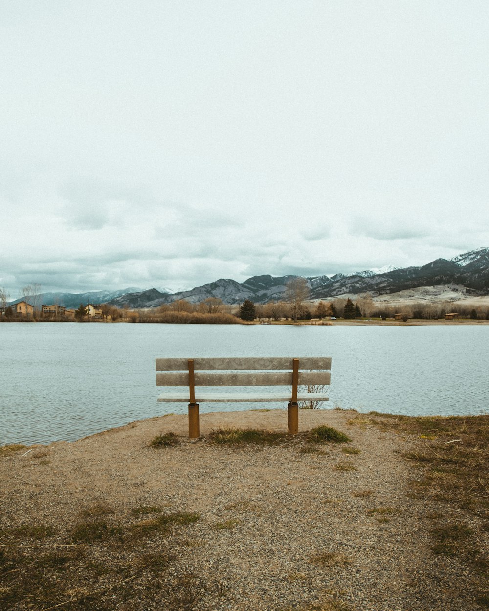 a wooden bench sitting in front of a lake