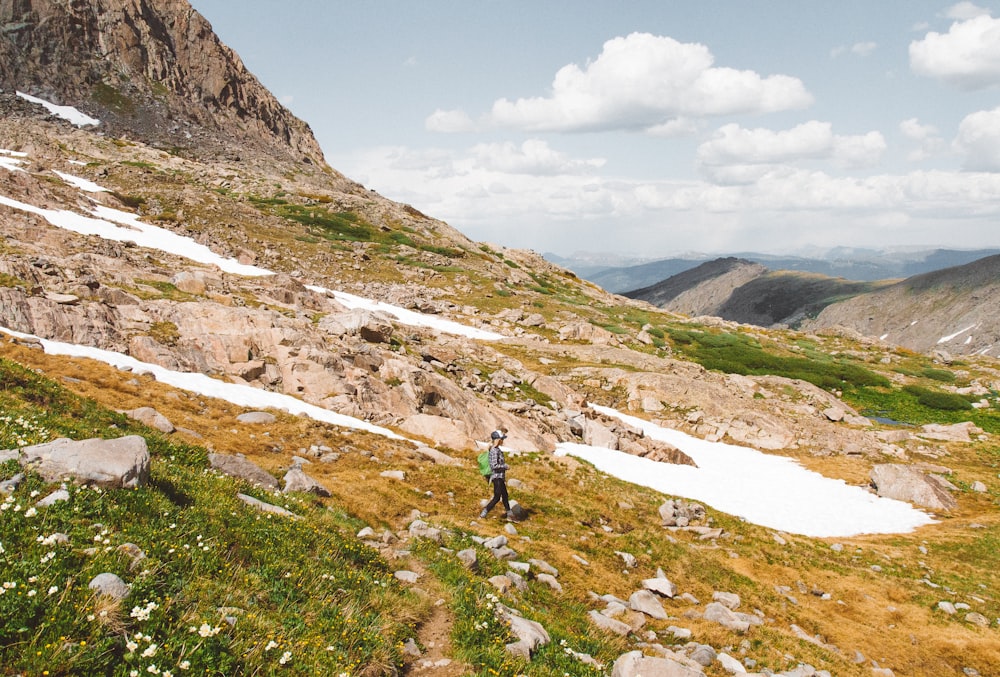 man walking on rock mountain