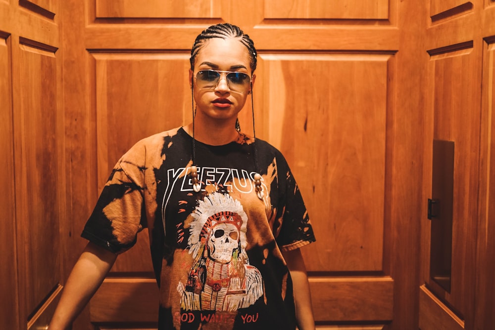 woman with sunglasses in room surrounded by wooden panels