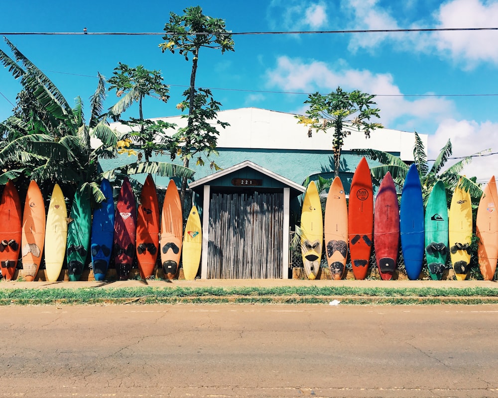 blue and white house surrounded by surfboards during daytime