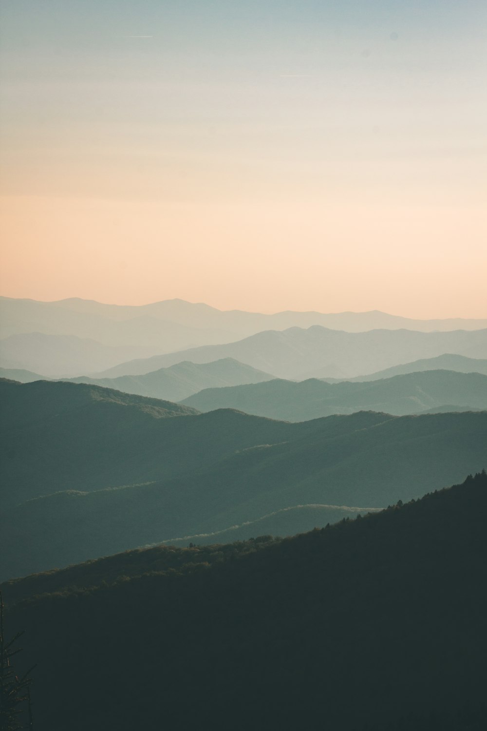 mountains under white mist at daytime