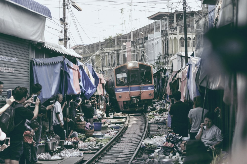 group of people standing near train