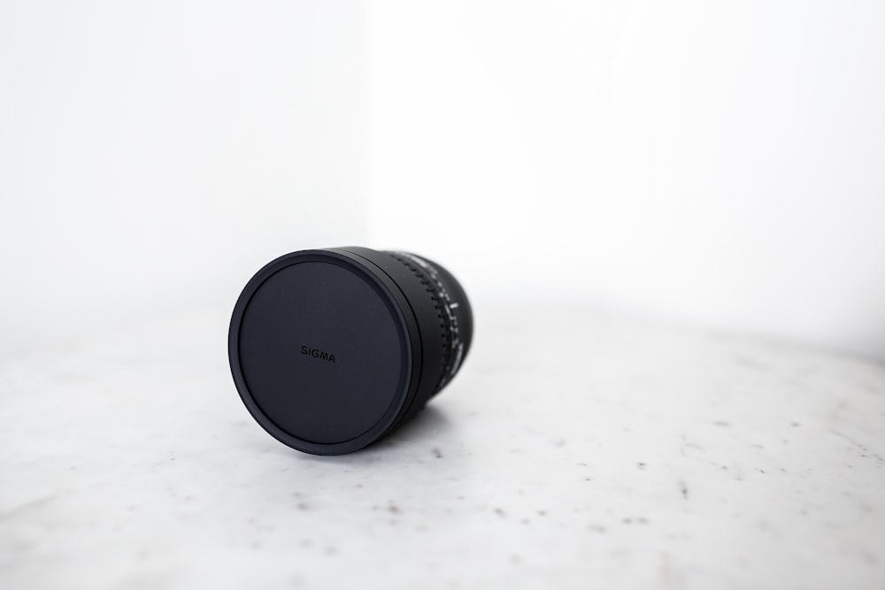 black camera lens on white surface