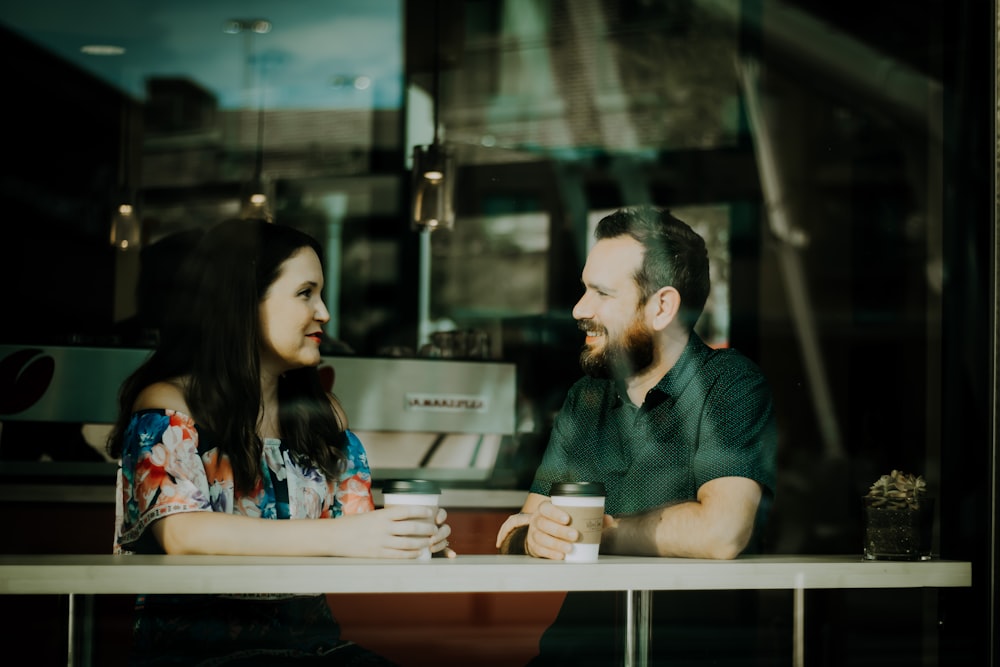 Man and a woman having a conversation in a Bee Cave Coffee Co. shop