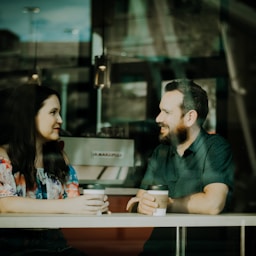 couple drinking coffee inside coffee shop