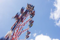 A vibrant roller coaster twisting against a bright blue sky, capturing the thrill of the park.