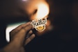 person holding Hello! sticker